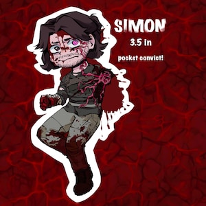 Puede incluir: Una pegatina de dibujos animados de un personaje llamado Simon, de 8,9 cm de altura, con aspecto herido. El personaje está representado con pelo oscuro, una camisa gris y salpicaduras de sangre. También se incluye el texto "pocket convict!".