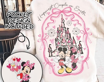 May include: White sweatshirt with a pink graphic of Mickey and Minnie Mouse in front of Cinderella's Castle. The graphic includes the text "Happiest Couple on Earth". A separate image shows a pocket design of Minnie Mouse holding balloons.