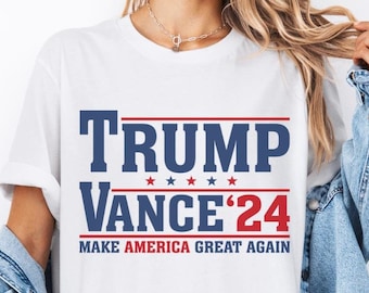 May include: White t-shirt with blue and red text that reads "Trump Vance'24 Make America Great Again".