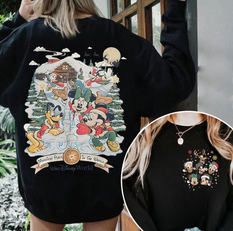 May include: Black sweatshirt with a Christmas-themed design featuring Mickey Mouse and friends in a snowy winter scene. The text on the sweatshirt reads "Happiest Place In The World (Walt Disney World)".