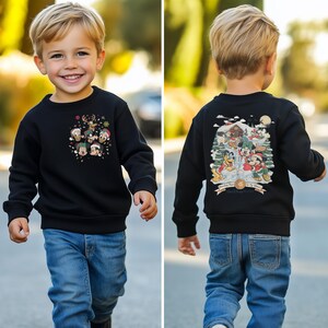 May include: A black sweatshirt with a Christmas-themed design featuring Mickey Mouse and friends. The front of the sweatshirt has a circular design with Mickey Mouse and friends wearing Santa hats. The back of the sweatshirt has a scene of Mickey Mouse and friends celebrating Christmas in a snowy village.