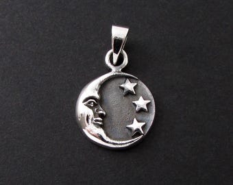 May include: A silver-toned pendant featuring a crescent moon with a face and three stars. The pendant has a loop at the top for a chain. The design is set against a dark background.