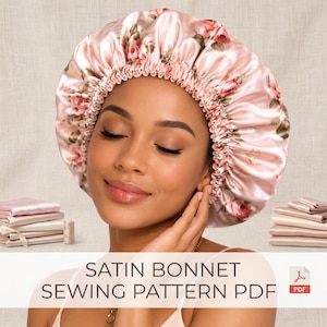 May include: A light pink satin bonnet featuring a floral rose pattern with a gathered elastic edge. The text SATIN BONNET SEWING PATTERN PDF is displayed at the bottom, accompanied by a small red PDF icon and stacks of folded fabric.