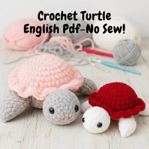 May include: Two crocheted turtle toys, one pink and grey, the other red and white, are displayed on a wooden surface. The turtles have black eyes and are surrounded by yarn and crochet hooks. Text on the image reads "Crochet Turtle English Pdf-No Sew!"