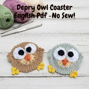 May include: Two crocheted owl coasters, one tan and one light blue, with black and white eyes and orange beaks. The coasters have yellow feet. The text "Depry Owl Coaster English Pdf - No Sew!" is at the top of the image.