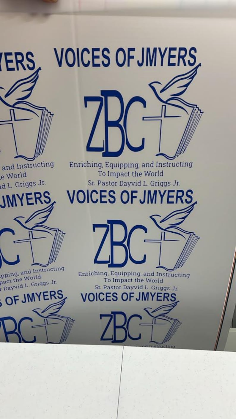 May include: A white sheet featuring multiple blue printed logos. Each logo displays the text VOICES OF JMYERS, ZBC, and the phrase Enriching, Equipping, and Instructing To Impact the World, along with the name Sr. Pastor Dayvid L. Griggs Jr. and a dove icon.