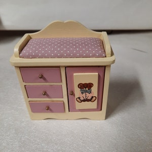 Vintage 1990s NOS miniature baby changing table with bear on front pink and yellow with door and drawers that open.