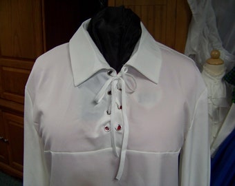May include: White long-sleeved shirt with a lace-up front and a collar. The shirt is made of a smooth, silky fabric.