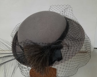 Ladies Vintage wool gray hat with feathers and black Tulle around outter edge.