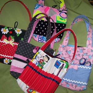 May include: A collection of six small, colorful fabric bags with different patterns and designs. The bags have handles and are made of various fabrics, including polka dots, gingham, and floral prints.