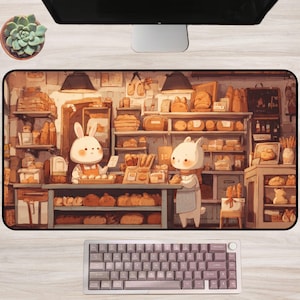May include: A rectangular desk mat with a bakery scene featuring cartoon animals. The mat has a light brown colour scheme and a keyboard at the bottom. A succulent plant in a pot is visible at the top left.
