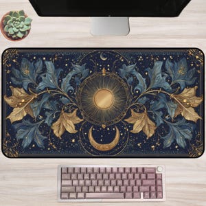 May include: A rectangular desk mat featuring a dark navy blue background with a central gold sun and a crescent moon below. The design includes intricate gold and blue floral patterns, swirling vines, and scattered stars across the surface.