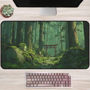 May include: A rectangular desk mat featuring a serene forest scene with a red torii gate. The mat has a green and brown color scheme, with a path leading to the gate. A keyboard with pink keycaps is in the foreground.