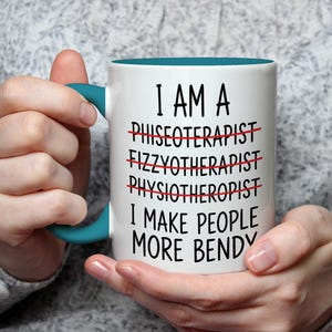May include: White ceramic mug with a teal handle and interior. The mug features the text "I AM A... I MAKE PEOPLE MORE BENDY" with crossed-out words above. A humorous gift for a physical therapist.