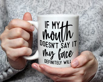 May include: White ceramic mug with a black inscription that reads "If my mouth doesn't say it my face definitely will."