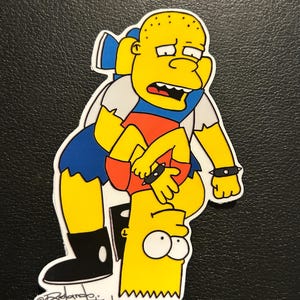 May include: A sticker featuring a yellow cartoon character holding another upside down. The top character wears a white shirt, blue shorts, and black boots. The bottom character is yellow with spiky hair. The sticker has the text "@Ricardo. The Artist".