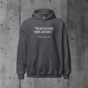 Hoodie with an empowering Bible verse about relying on God's strength during life’s challenges. A perfect choice for those who value their faith deeply.