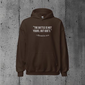 Christian pullover with the Bible verse "The battle is not yours, but God's." Suitable for wearing at church gatherings, daily errands, or simply sharing an uplifting message.