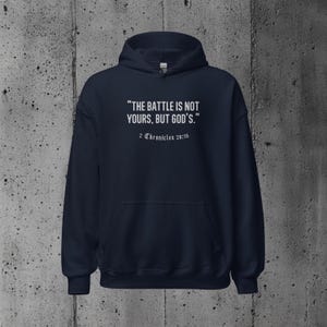 Faith-based hoodie displaying the motivational message "The battle is not yours, but God's." Ideal for Christians wanting to express their trust in God’s guidance.