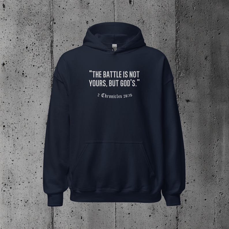 Faith-based hoodie displaying the motivational message "The battle is not yours, but God's." Ideal for Christians wanting to express their trust in God’s guidance.