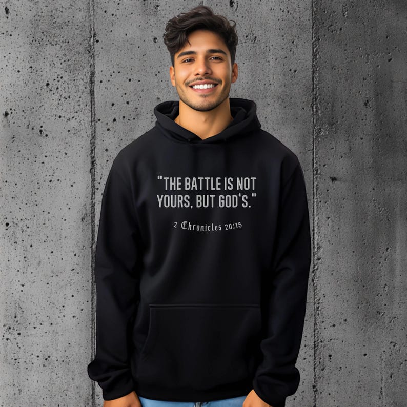Hoodie featuring an inspiring Bible verse: "The battle is not yours, but God's" from 2 Chronicles 20:15. Perfect for believers who want to carry a message of faith and strength.