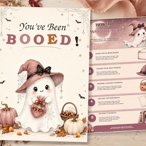 May include: A Halloween sign set featuring a white ghost wearing a pink witch hat, holding a heart-shaped bag, surrounded by pumpkins and spiderwebs. The text reads You've Been BOOED! and includes a How to Pass the Boo instruction sheet.