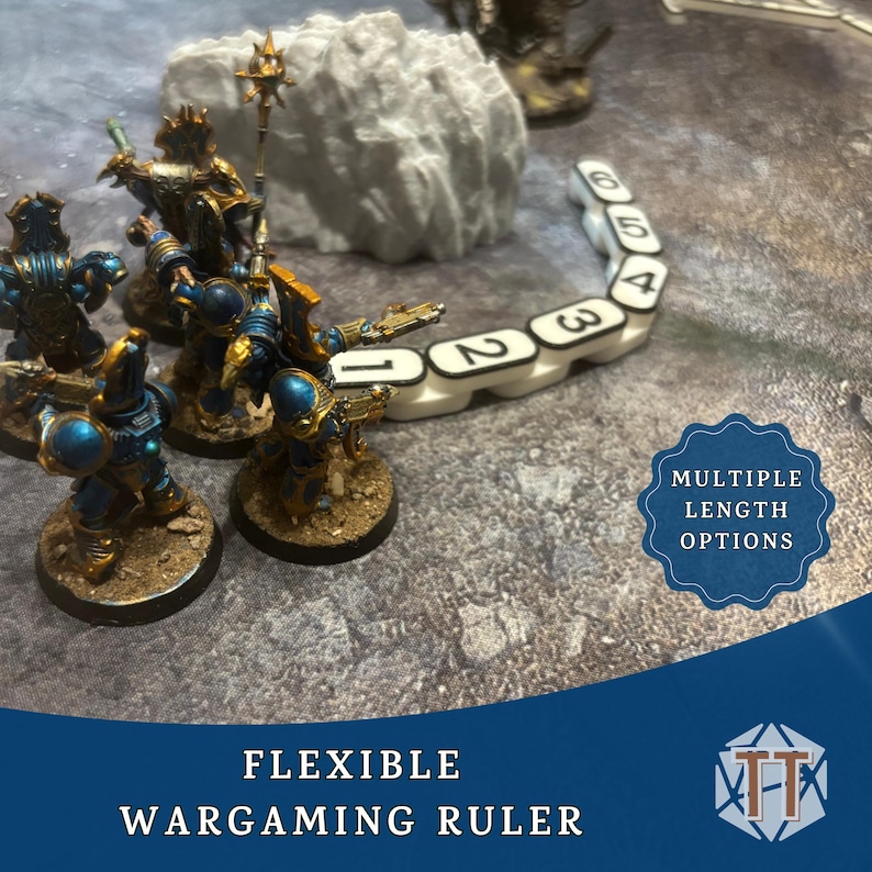 May include: A wargaming scene featuring miniature figures in blue and gold armor, a white flexible ruler with black numbers, and a rock formation. The image includes text that reads "FLEXIBLE WARGAMING RULER" and "MULTIPLE LENGTH OPTIONS."
