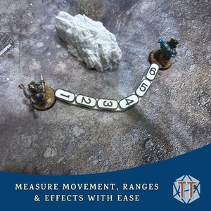 May include: A tabletop gaming accessory featuring a white, curved measuring tool with numbers 1-6, used to measure distances between two miniature figures. The image also includes a white rock and the text "MEASURE MOVEMENT, RANGES & EFFECTS WITH EASE".