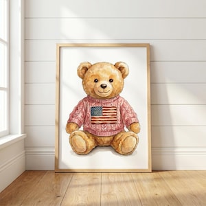 May include: A framed watercolour print of a teddy bear wearing a pink sweater featuring the American flag. The artwork is set against a white wall and wooden floor, creating a cosy and inviting atmosphere.