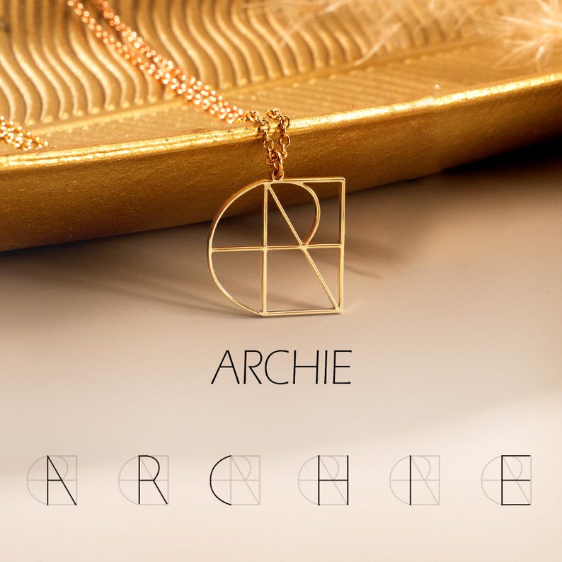 May include: Gold geometric necklace featuring an Archie monogram pendant. The pendant is a minimalist design with intersecting lines forming the letters A, R, C, H, I, and E.  The necklace is displayed on a gold tray. The word ARCHIE is printed below the necklace.  Additional smaller versions of the monogram are shown below the word ARCHIE.
Logo Name Necklace, Minimalist Logo Initials Design, Geometric Letter Jewelry, Couple Gift, Anniversary Gift, Christmas Gift, Gift for Girl