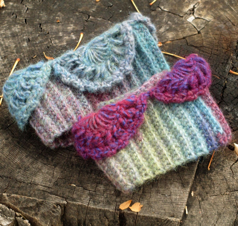 May include: Two crocheted wrist warmers with a striped pattern and a decorative crocheted trim. One warmer is blue and purple, the other is pink and green.