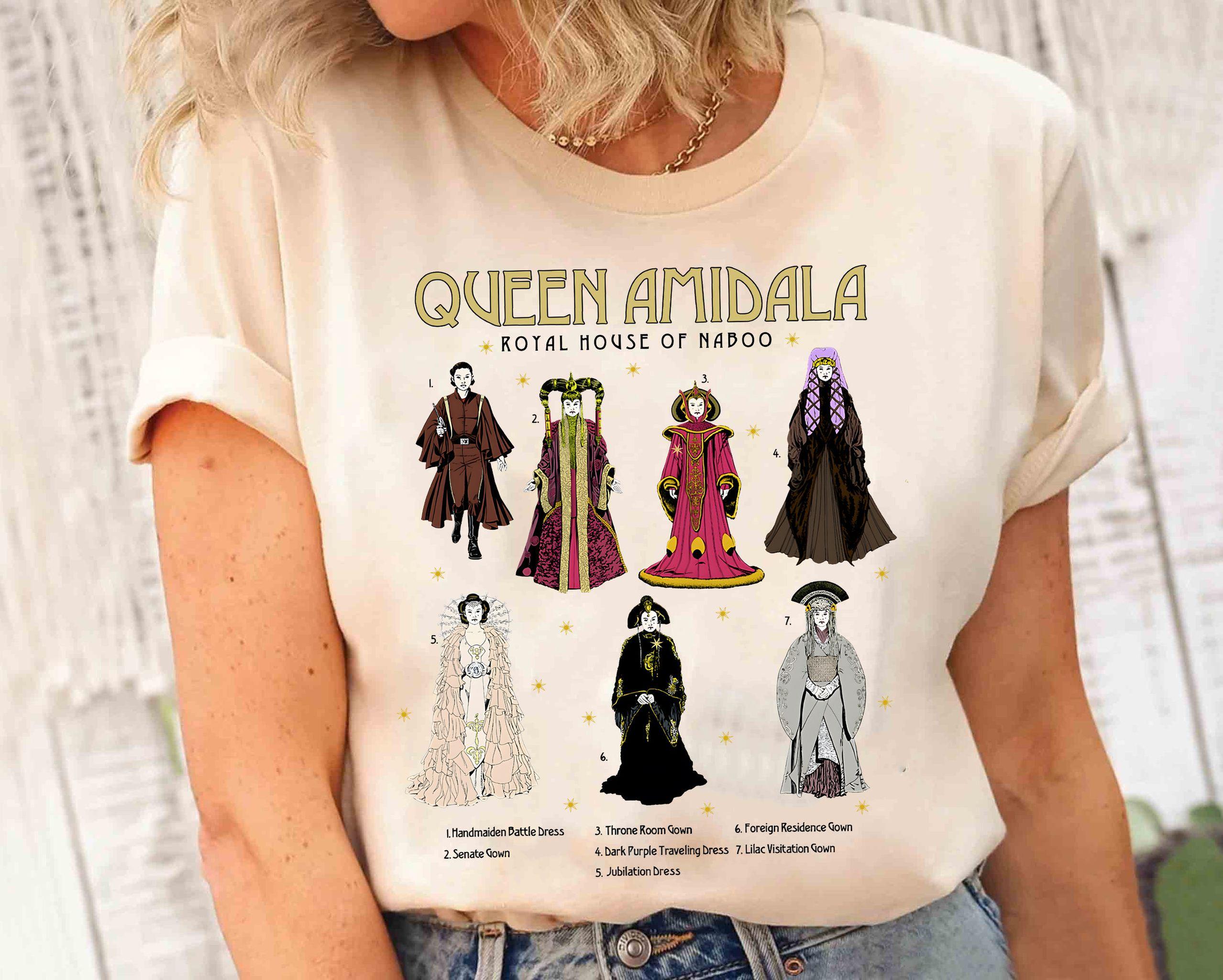May include: A white t-shirt with a graphic print of Queen Amidala from Star Wars. The graphic shows Queen Amidala in different outfits with the text "Queen Amidala Royal House of Naboo".