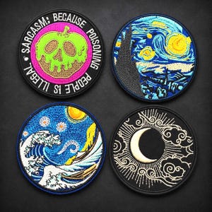 May include: Four circular embroidered patches. Top left: a green skull apple with the text SARCASM: BECAUSE POISONING PEOPLE IS ILLEGAL. Top right: a blue and yellow swirling night sky scene. Bottom left: a blue ocean wave with a yellow sun. Bottom right: a white crescent moon with clouds.