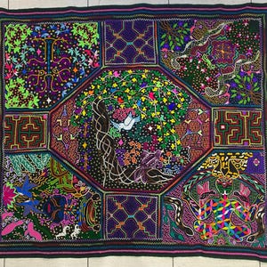 May include: A colorful embroidered tapestry with a central motif of a tree with birds and vines. The tapestry is divided into nine sections, each with a different design, including geometric patterns, animals, and flowers. The tapestry is made with a variety of colors, including red, green, blue, yellow, and purple.