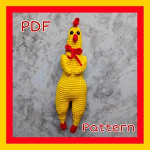 May include: A crochet pattern for a yellow chicken toy with red accents. The pattern is available as a PDF download. The chicken has a red bow around its neck and red feet.