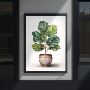 May include: Watercolor painting of a fiddle-leaf fig plant in a decorative pot, framed in black. The plant features large, green leaves with yellow-green highlights. The pot is a light brown with a textured design.