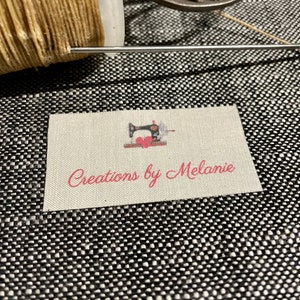 May include: A white fabric label with a pink sewing machine graphic and the text "Creations by Melanie".