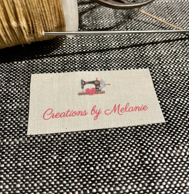 May include: A white fabric label with a pink sewing machine graphic and the text "Creations by Melanie".