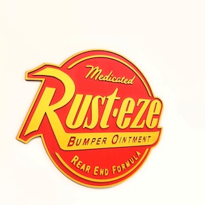 May include: A red and yellow sign with the text "Rust-eze Bumper Ointment Rear End Formula." The sign is circular with a yellow border and lettering. The text "Medicated" is above the main text.
