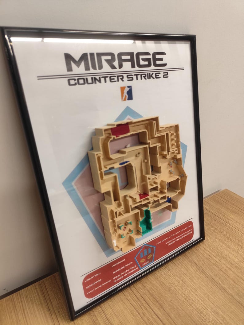May include: A framed 3D map of the Mirage map from Counter-Strike 2. The map is made of beige plastic and features a variety of colors, including red, blue, and green. The frame is black and has a white background with the words "MIRAGE" and "COUNTER-STRIKE 2" printed in black.