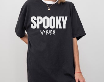 May include: Black oversized t-shirt with white text that reads "SPOOKY VIBES".