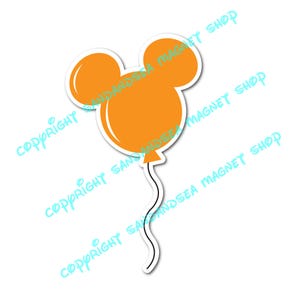 May include: Orange balloon sticker in the shape of Mickey Mouse's head. The balloon has a white outline and a black string. The sticker is on a white background. The text "COPYRIGHT SAND AND SEA MAGNET SHOP" is printed diagonally.