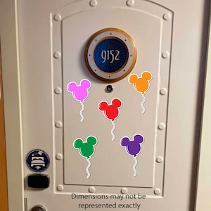 May include: A white door with a porthole window showing the number 9152. Six colourful Mickey Mouse-shaped balloon stickers are attached to the door. The balloons are pink, orange, red, green, and purple. The text "Dimensions may not be represented exactly" is at the bottom.