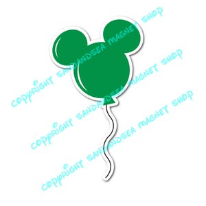 May include: A green balloon-shaped magnet with a white outline, resembling Mickey Mouse's head. The magnet has a curved string and the text "COPYRIGHT SANDANDSEA MAGNET SHOP" in a light blue colour.