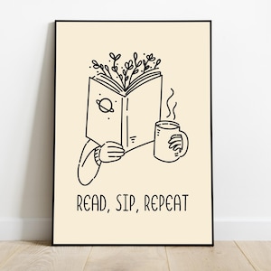 以下が含まれることがあります： コーヒーカップを持った人が本を読んでいる白黒のイラスト。イラストの下に「READ, SIP, REPEAT」というテキストがあります。