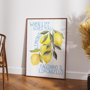 May include: A white framed poster with a watercolor illustration of lemons on a branch. The text on the poster reads "When life gives you lemons, facciamo il limoncello."