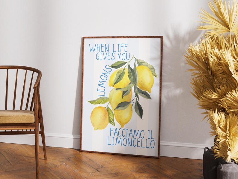 May include: A white framed poster with a watercolor illustration of lemons on a branch. The text on the poster reads "When life gives you lemons, facciamo il limoncello."