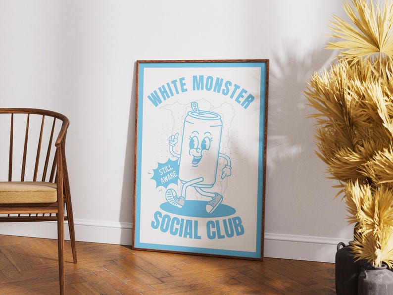 May include: A framed poster with a cartoon illustration of a smiling soda can character in light blue on a white background. The poster reads "WHITE MONSTER SOCIAL CLUB" with the words "STILL AWAKE" on a speech bubble.