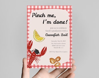 May include: A graduation announcement with a red and white gingham border. The invitation features the text "Pinch me, I'm done!" and "Crawfish Boil." A red crawfish wearing a graduation cap is illustrated on the invitation.