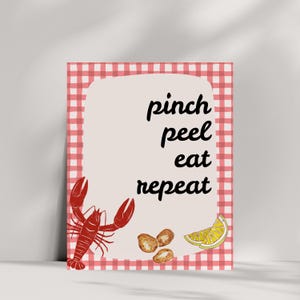 K&ouml;nnte beinhalten: Ein roter und wei&szlig;er karierter Hintergrund mit einem wei&szlig;en Rechteck in der Mitte. Das Rechteck enth&auml;lt den Text "pinch peel eat repeat" in Schwarz. Im Rechteck befinden sich ein roter Hummer, eine Zitronenscheibe und ein Haufen Kartoffeln.